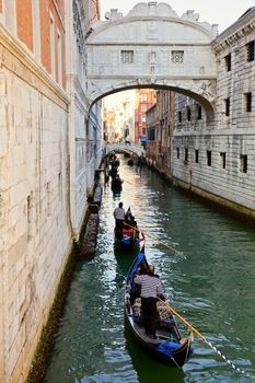 Romantic gondola cruise through the canals of Venice in evening light