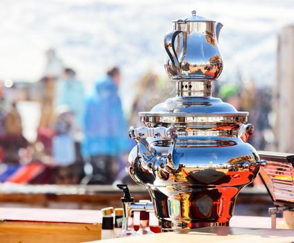 Shiny electric water boiler Samovar at Italian ski resort