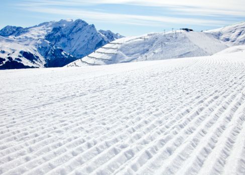 Fresh snow on a ski slope at Val Di Fassa ski resort in Italy