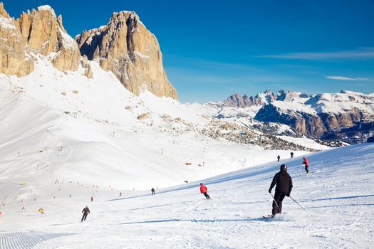 Skier going down the slope at Val Di Fassa ski resort in Italy