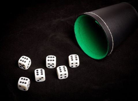 Six dice with number six facing up on black board