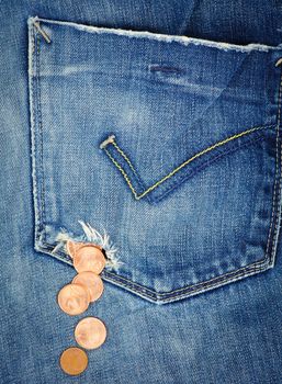 Money fall out from a hole in jeans pocket