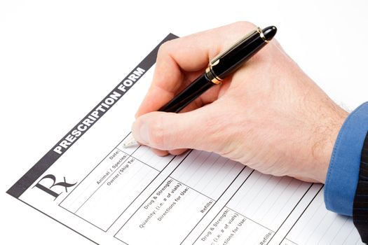 Hand with pen over blank veterinarian prescription form