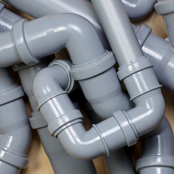 Grey PVC sewer pipes background