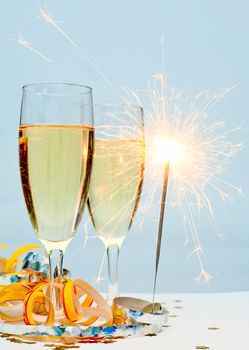 Two glasses of champagne with ribbons and burnning sparkler