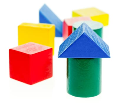 Colourful wooden children's blocks on white background, shallow dof