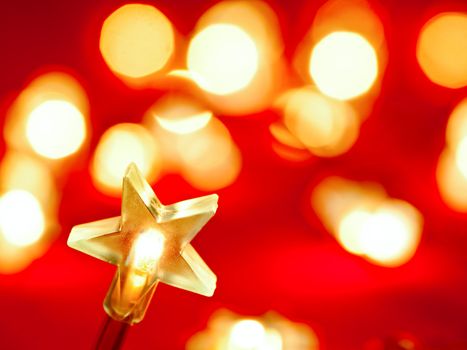 Star shaped Christmas light with blured lights in background, very shallow DOF