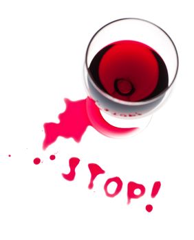 The word Stop written with poured red wine