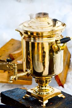 Vintage smoking golden Samovar, the traditional russian water boiler