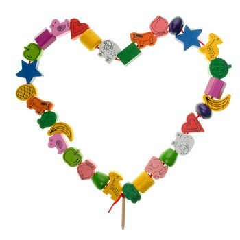 Colorful wooden toy beads in the shape of heart on white background