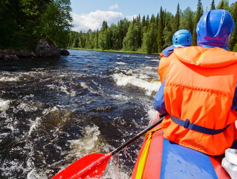 Rafters in a rafting boat on Pistojoki river in Karelia, Russia