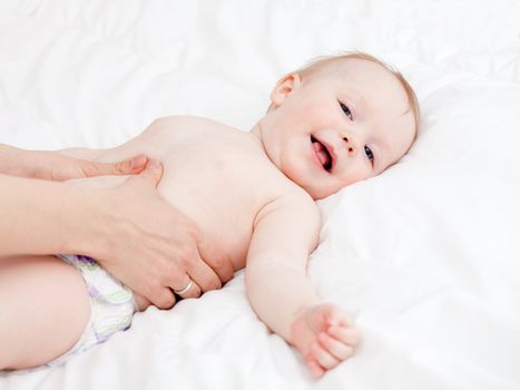 Mother massaging her child, shallow focus