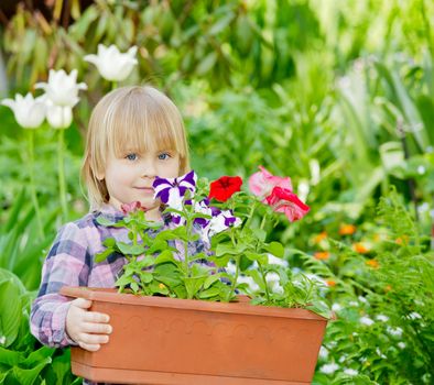 Little girl holding container with flowers