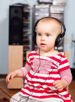 Cute little baby girl listening to a music