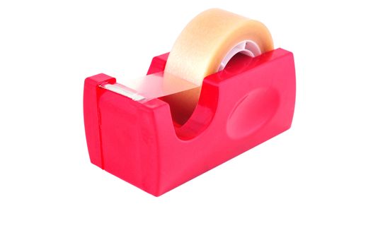 Sticky plastic tape in a roll on the red stand photographed against a white background