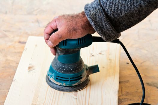 Work keeps hand sanding mashin, which he sanding wooden board