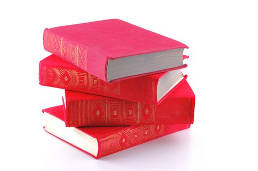 A stack of books with red covers lies in front of white background