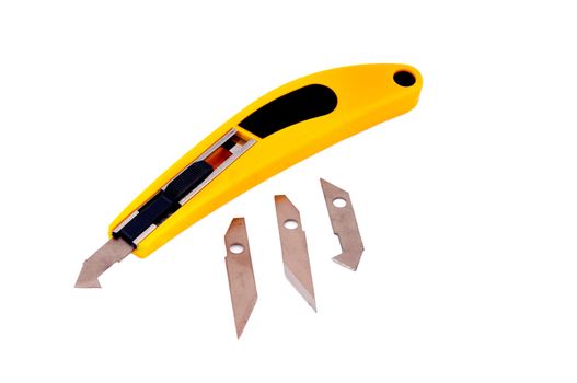 Knife with a yellow handle to work on the cardboard and plastic sheets and spare blades