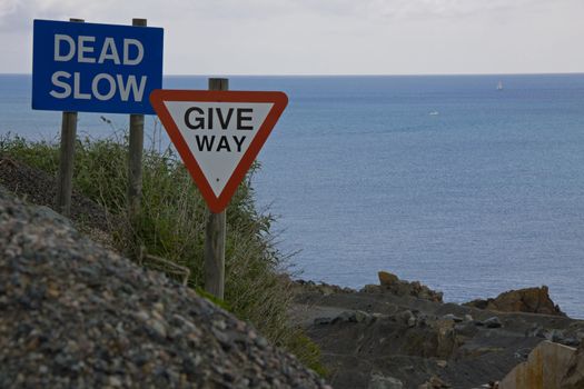 Road warning signs at a cliff edge
