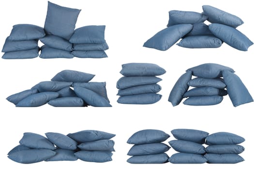 seven stacks of blue denim pillows isolated on white