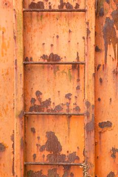 four steps of old orange and rusty container on vertical image