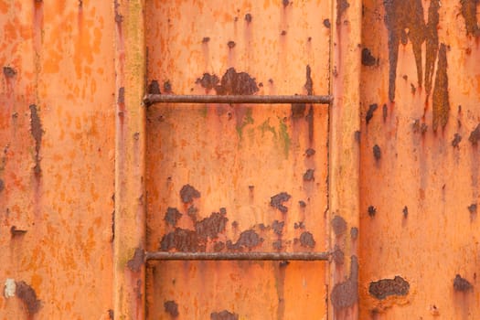 two steps of old orange and rusty container