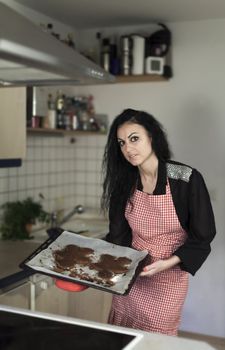 woman in a kitchen with gingerbread