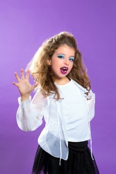 Children fashion makeup kid girl trying to scare gesture on purple