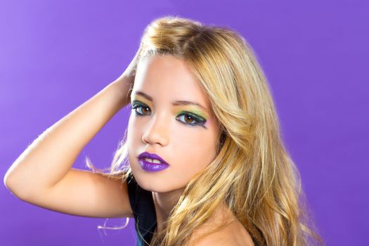 Blond children fashiondoll girl fashion makeup on purple background