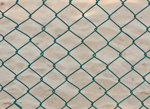 green seamless fence chain on sand background