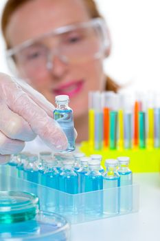 chemical laboratory scientist woman working with glass blue bottles