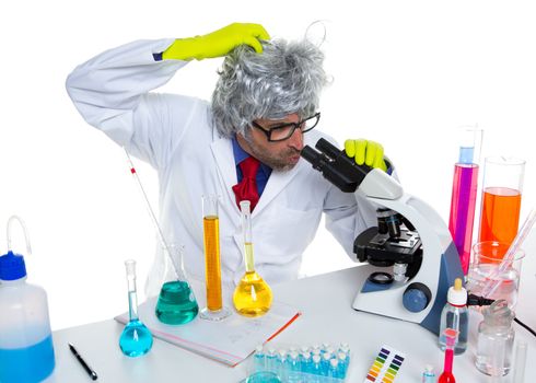 Crazy mad nerd scientist at laboratory microscope thinking gesture