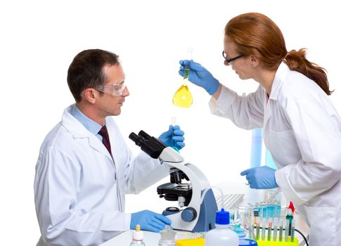 laboratory with two scientist working with test tubes flask and microscope