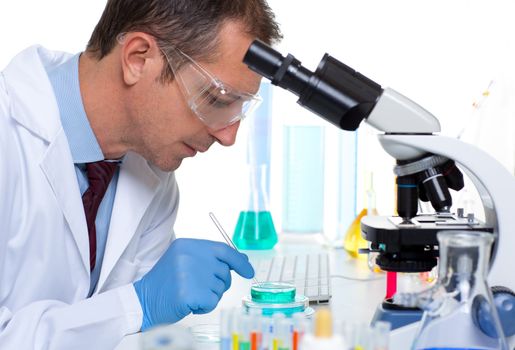 laboratory scientist working at lab with test tubes and microscope