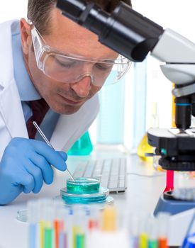 laboratory scientist working at lab with test tubes and microscope