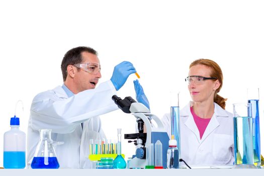 laboratory with two scientist working with test tubes flask and microscope