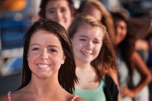Row of happy smiling female teenagers outdoors