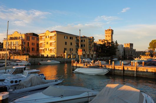 Sunset view of the luxury yacht port in Sirmione on Lake Garda in Italy.