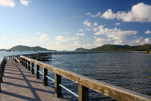 concrete jetty with railing over sea at Sattaheep beach, Thailand