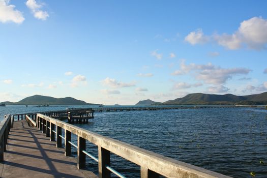 concrete jetty with railing over sea at Sattaheep beach, Thailand