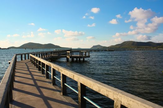 concrete jetty with railing over sea at Sattaheep beach, Thailand