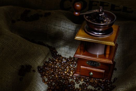 Coffee Mill with beans and burlap. still life