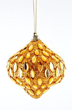   gold bump, Christmas decorations hanging on a golden thread against the white background