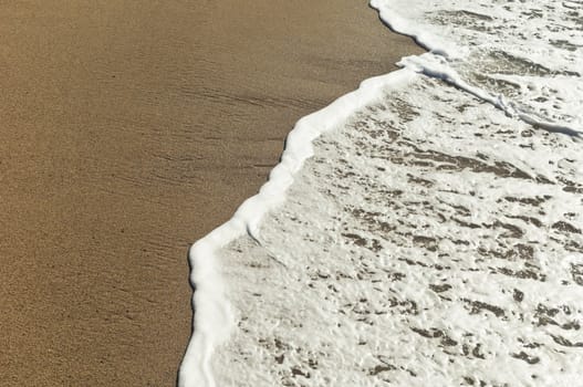 Closeup of beautiful white sea foam and waves