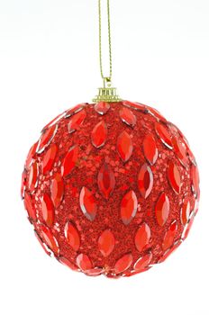 red ball, Christmas decorations hanging on a golden thread against a white background