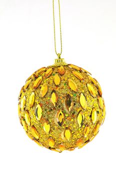 golden ball, Christmas decorations hanging on a golden thread against a white background