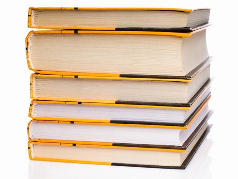 Big stack of yellow books isolated on white background