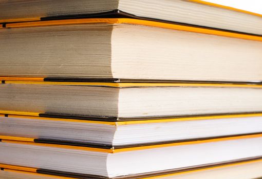 Big stack of yellow books isolated on white background