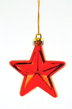 Red five-pointed star toy Christmas tree against a white background