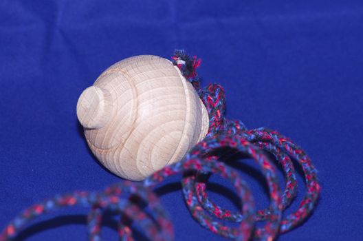 Wooden whirligig on blue background